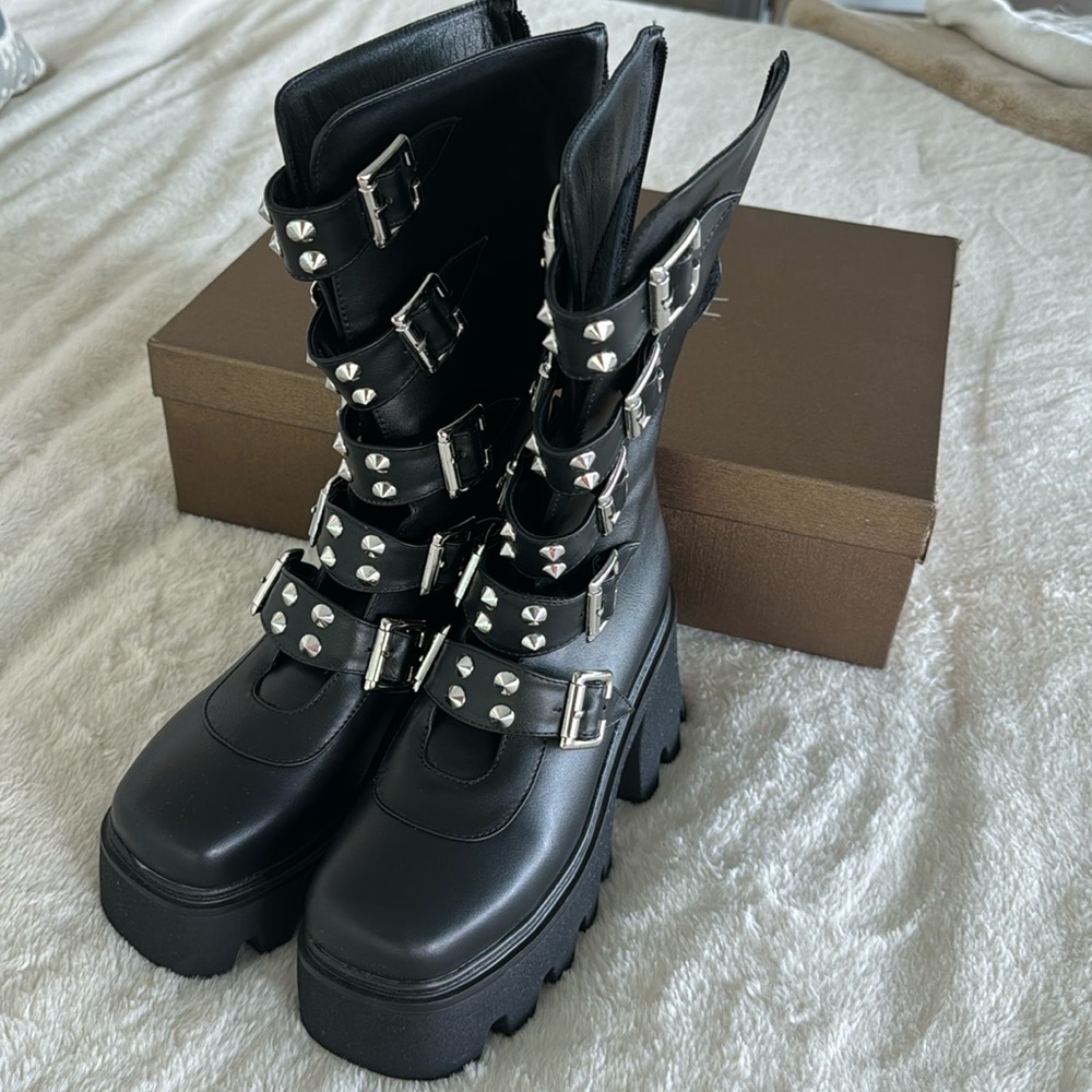 Chunky Black buckle zipper boots.